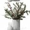 Bouquet with eucalyptus and flowers in a white vase Free Download